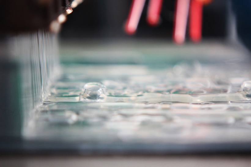 Close-up of adhesive application during production